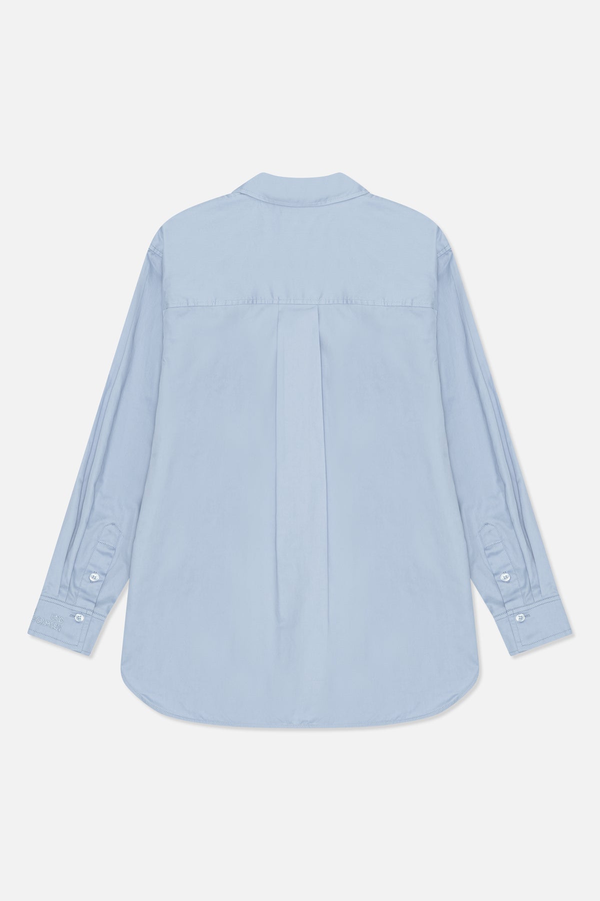 Back view of a pale blue long-sleeved shirt with a pointed collar, back yoke, center pleat and buttoned cuffs.