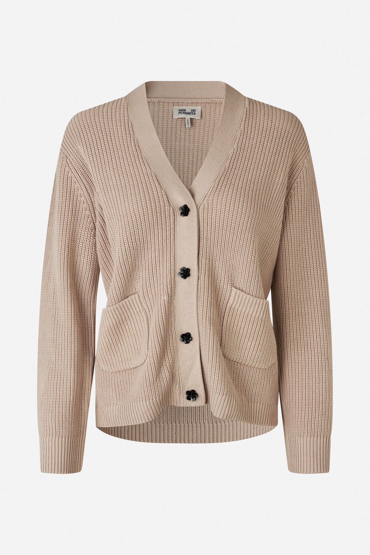 Front view of a beige rib-knit cardigan with a V-neck, black flower-shaped buttons and two patch pockets.