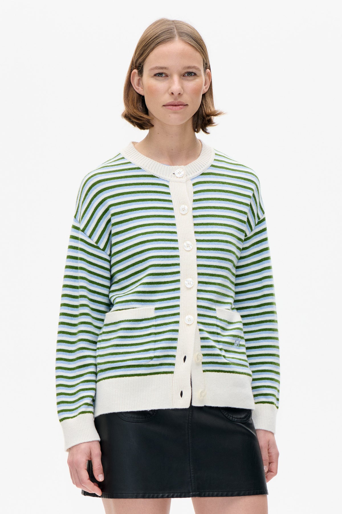 Front view of a cream knit cardigan with green and pale blue horizontal stripes, button fastening and ribbed trim.