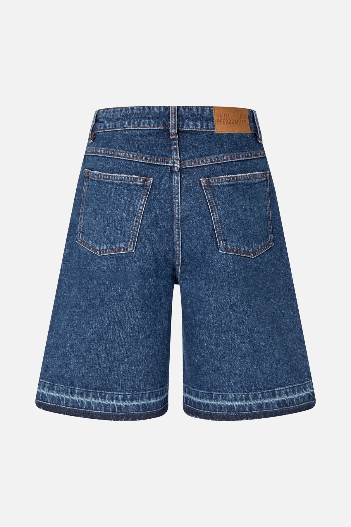 Back view of wide-leg dark blue jeans with contrasting stitching, two patch pockets and a tan waistband label.