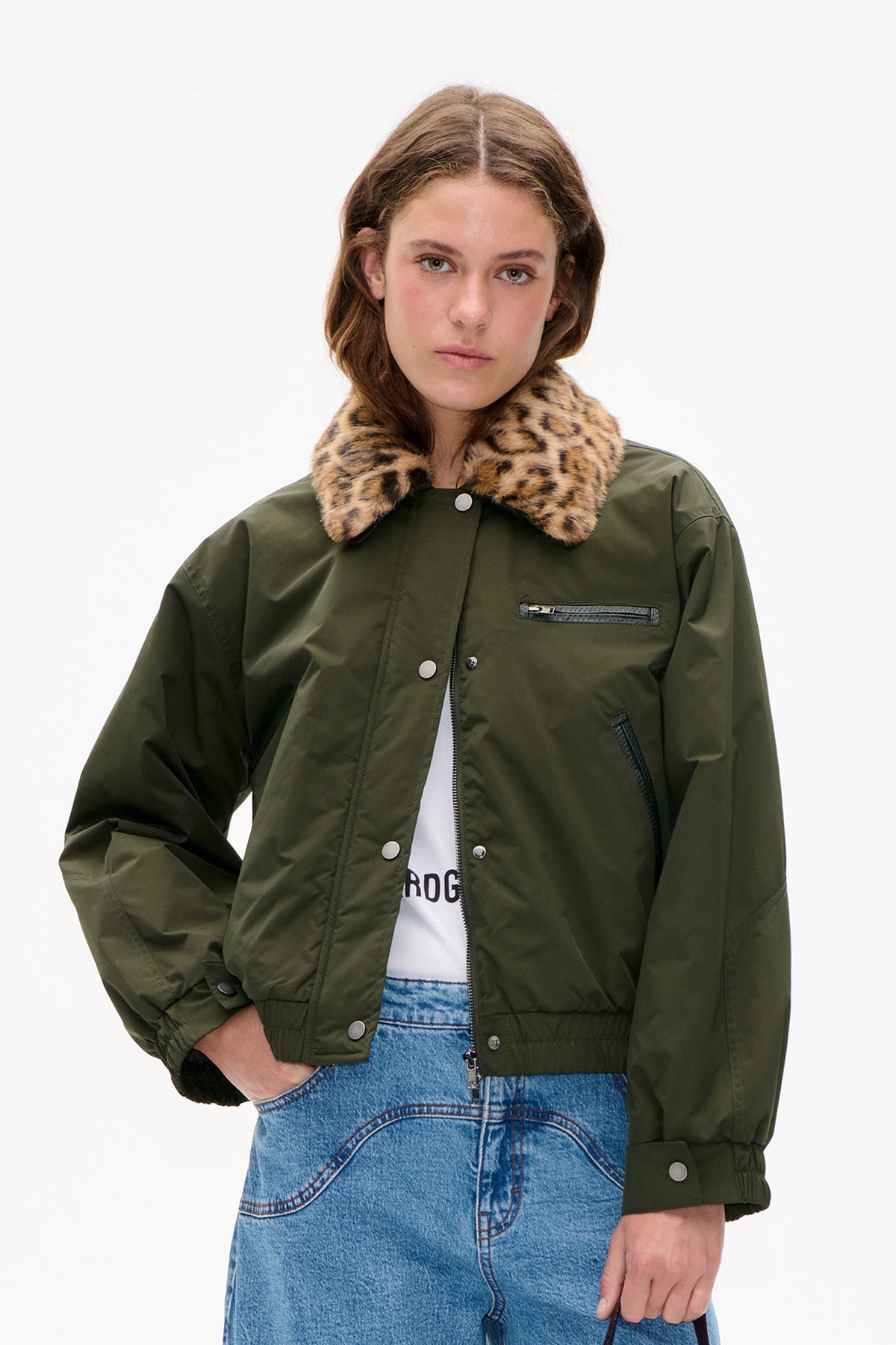 Front view of an olive green jacket with a tan and black leopard-print collar, snap fastenings and zip pockets.
