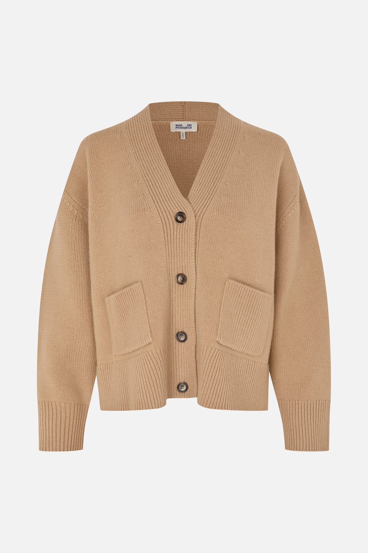 Front view of a beige knitted cardigan with a V-neck, dark buttons, two patch pockets and ribbed trim.
