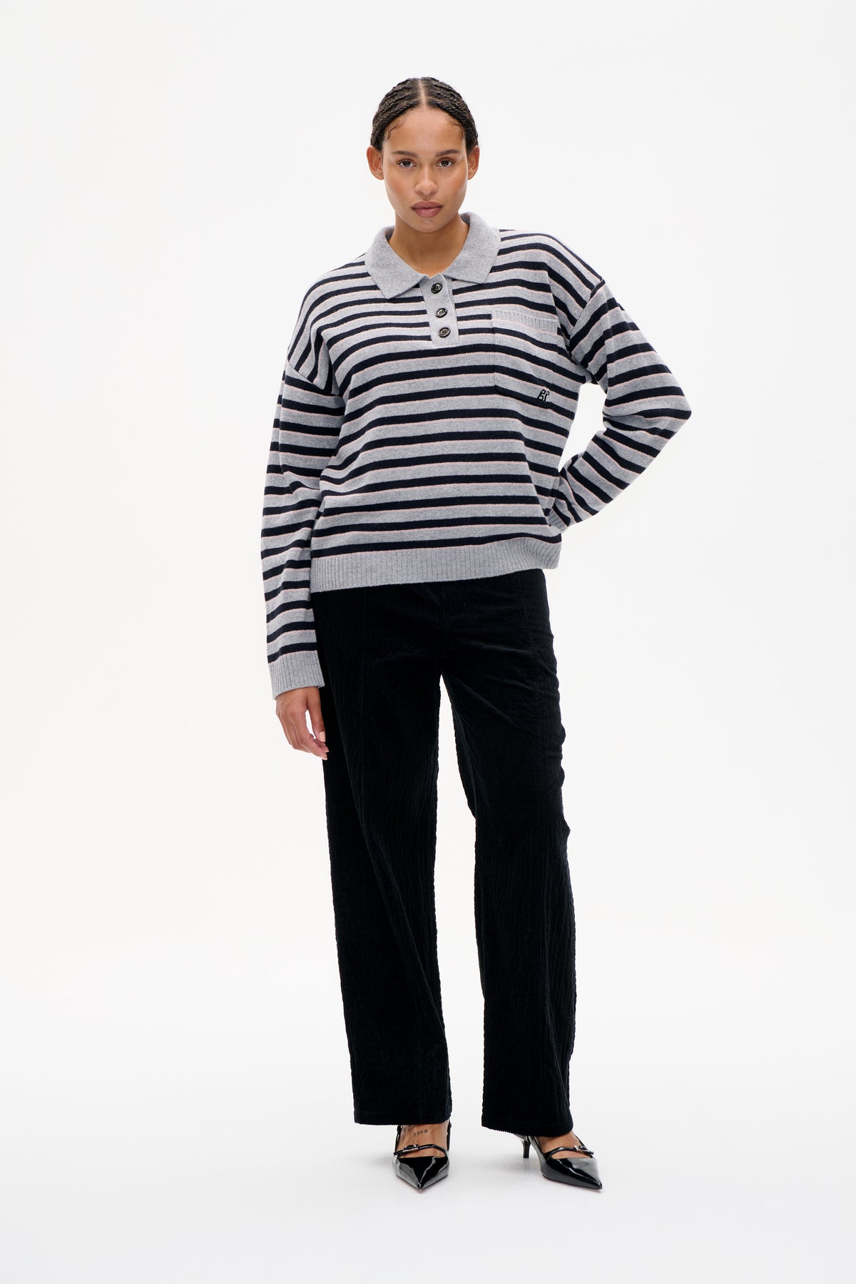 Front view of a grey striped knit polo sweater with navy and pale pink bands, collar, button placket and chest pocket.