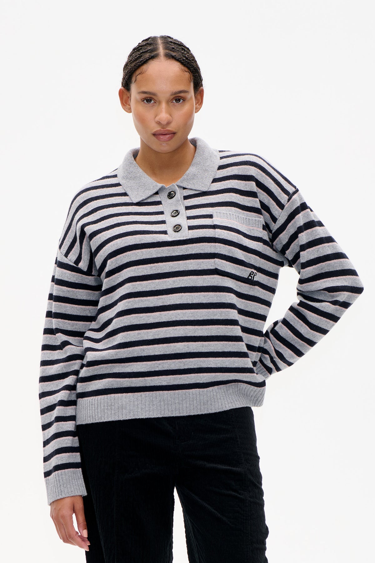 Front view of a grey knit rugby-style sweater with navy and pale pink horizontal stripes, a button placket and chest pocket.