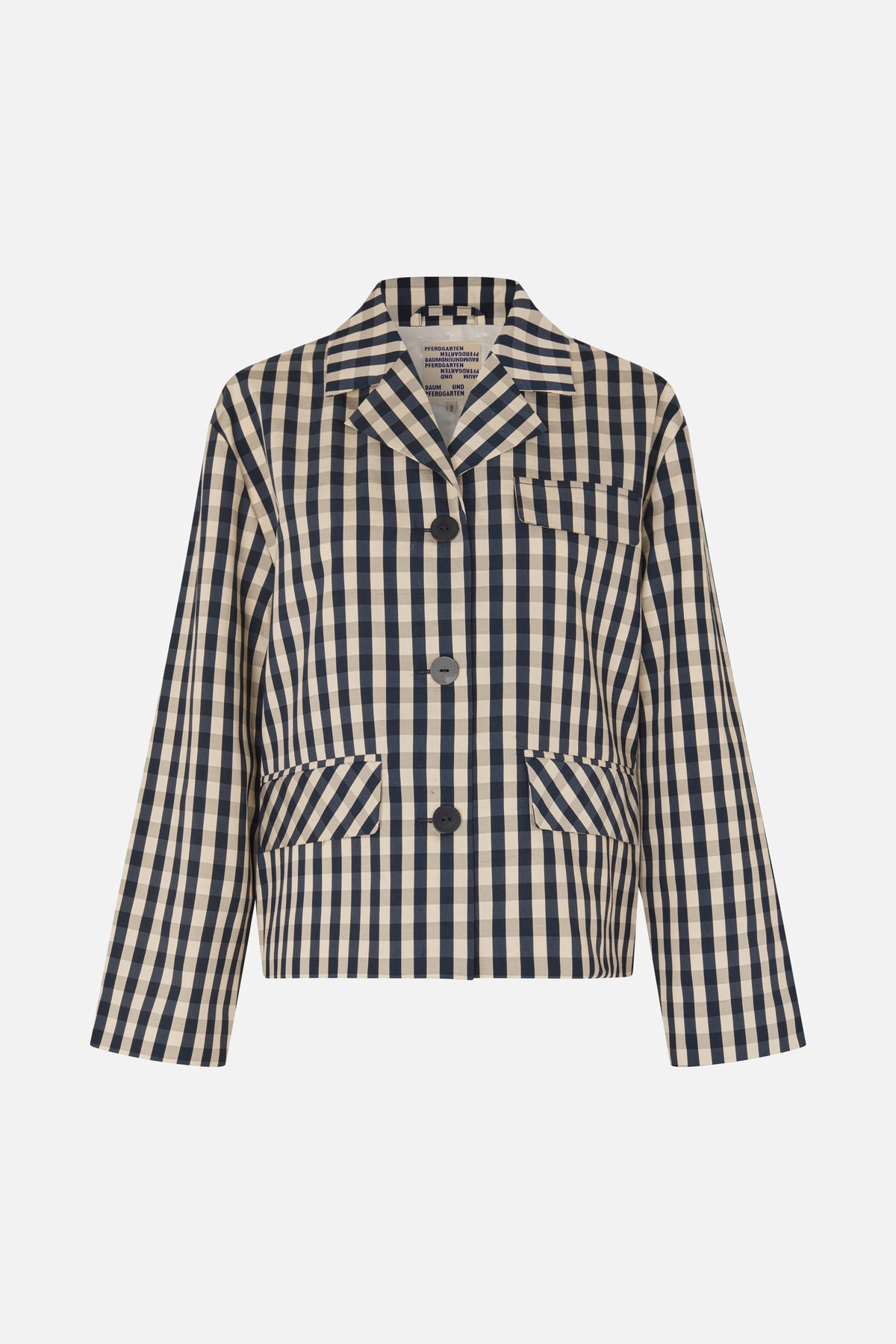 Front view of a beige and navy checked cropped jacket with notched lapels, dark buttons, a chest pocket and large flap pockets.