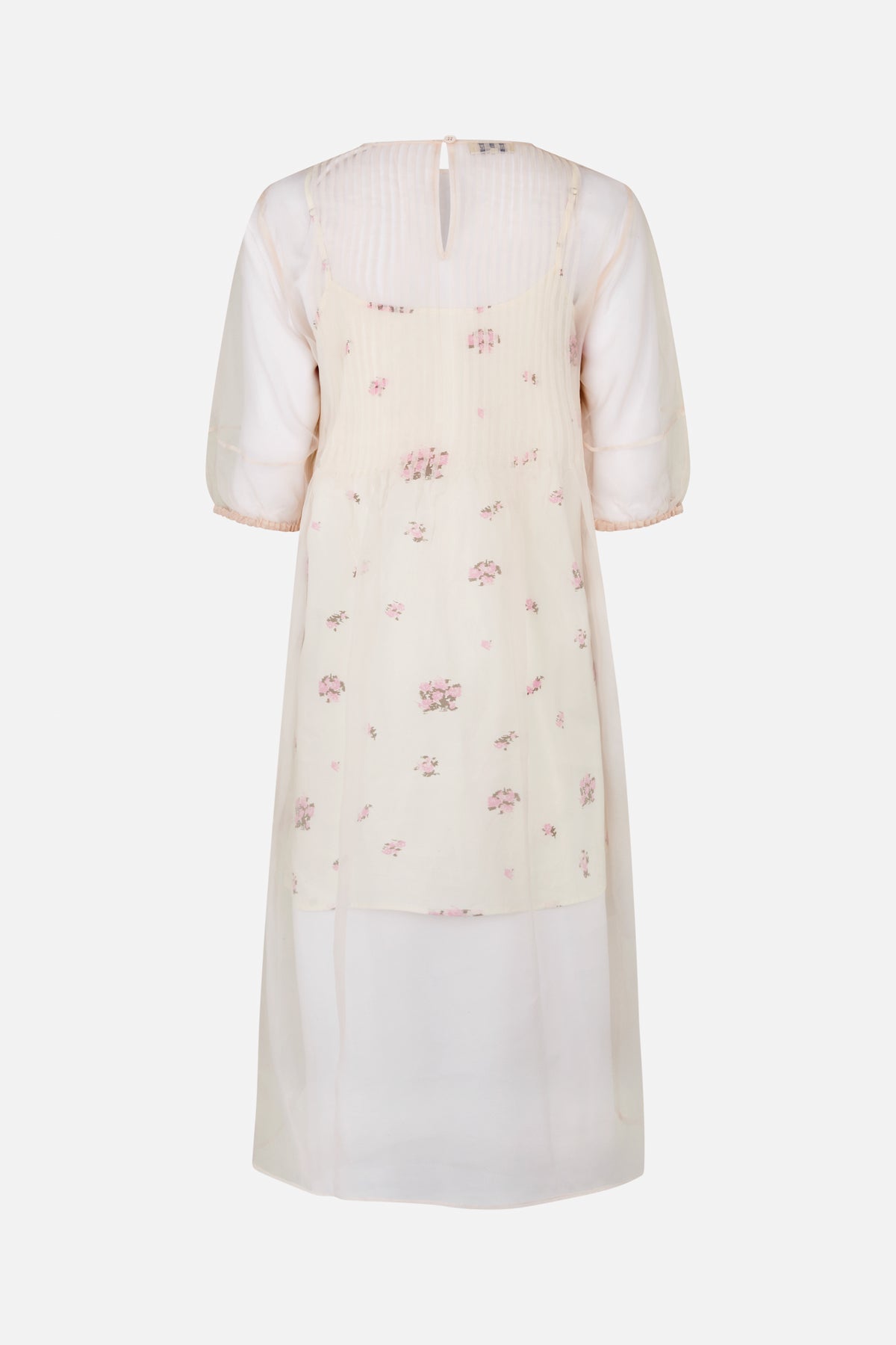 Back view of a sheer ivory dress with scattered pink floral clusters, puff sleeves, a small neckline keyhole and long translucent overlay.