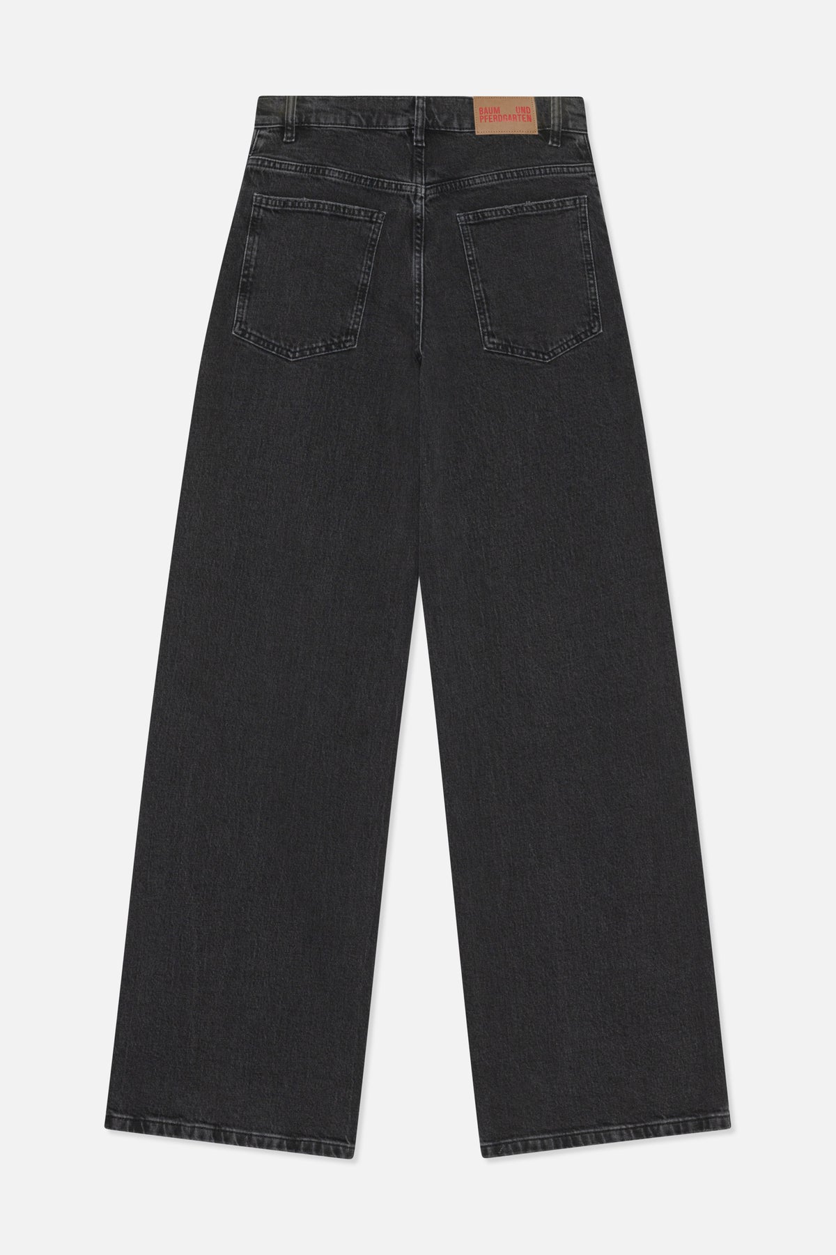Back view of charcoal-black wide-leg jeans with two patch pockets and a tan branded waistband patch.