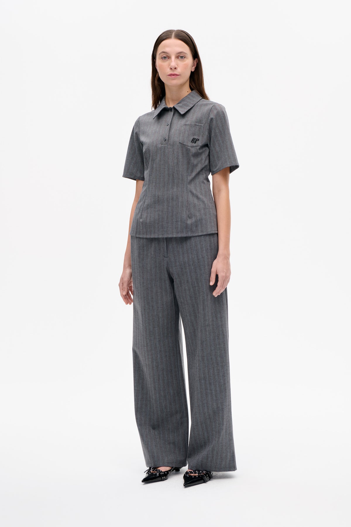 Front view of a grey subtly striped short-sleeve collared top with chest pocket and BP lettering, paired with matching wide-leg trousers.
