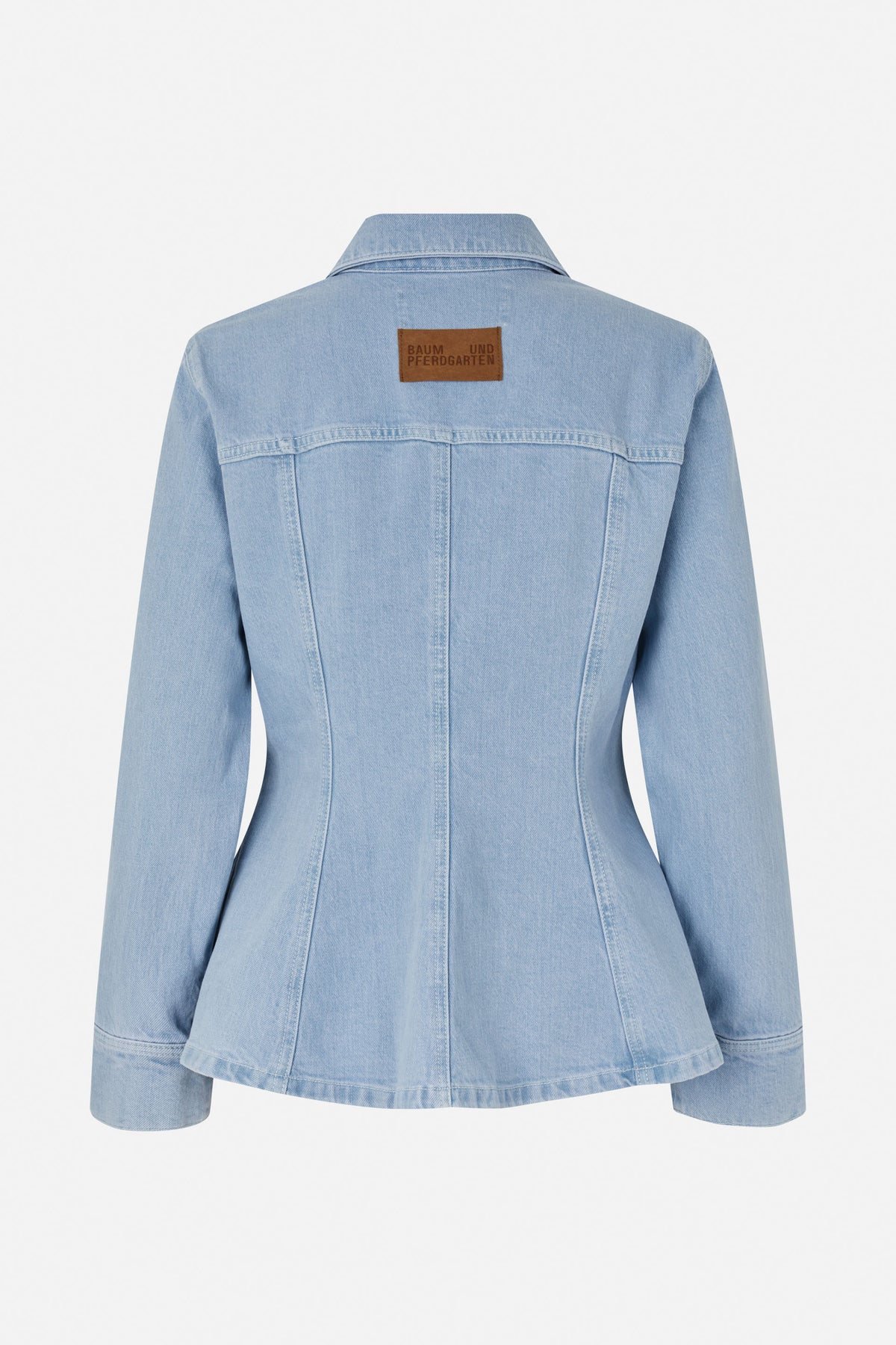 Back view of a light-wash denim jacket with a pointed collar, contoured seams, flared hem, and brown logo patch.