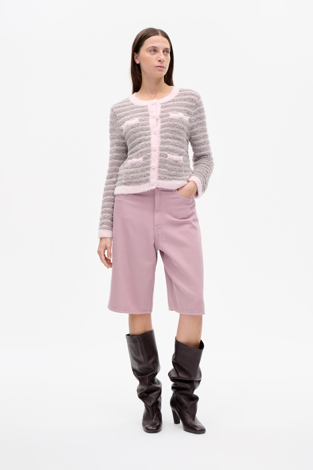 Front view of a model wearing a fuzzy grey-and-cream striped cardigan with pale pink trim and pockets, paired with mauve wide-leg cropped trousers.