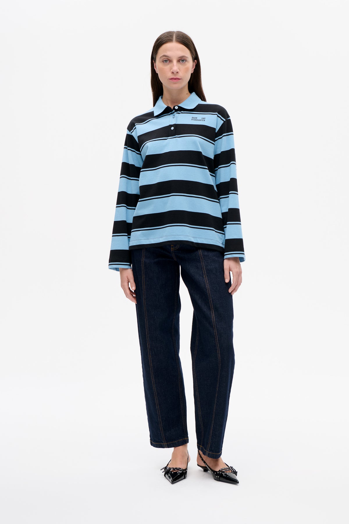 Front view of a model wearing a light blue and black striped long-sleeve polo shirt with a collar and button placket.