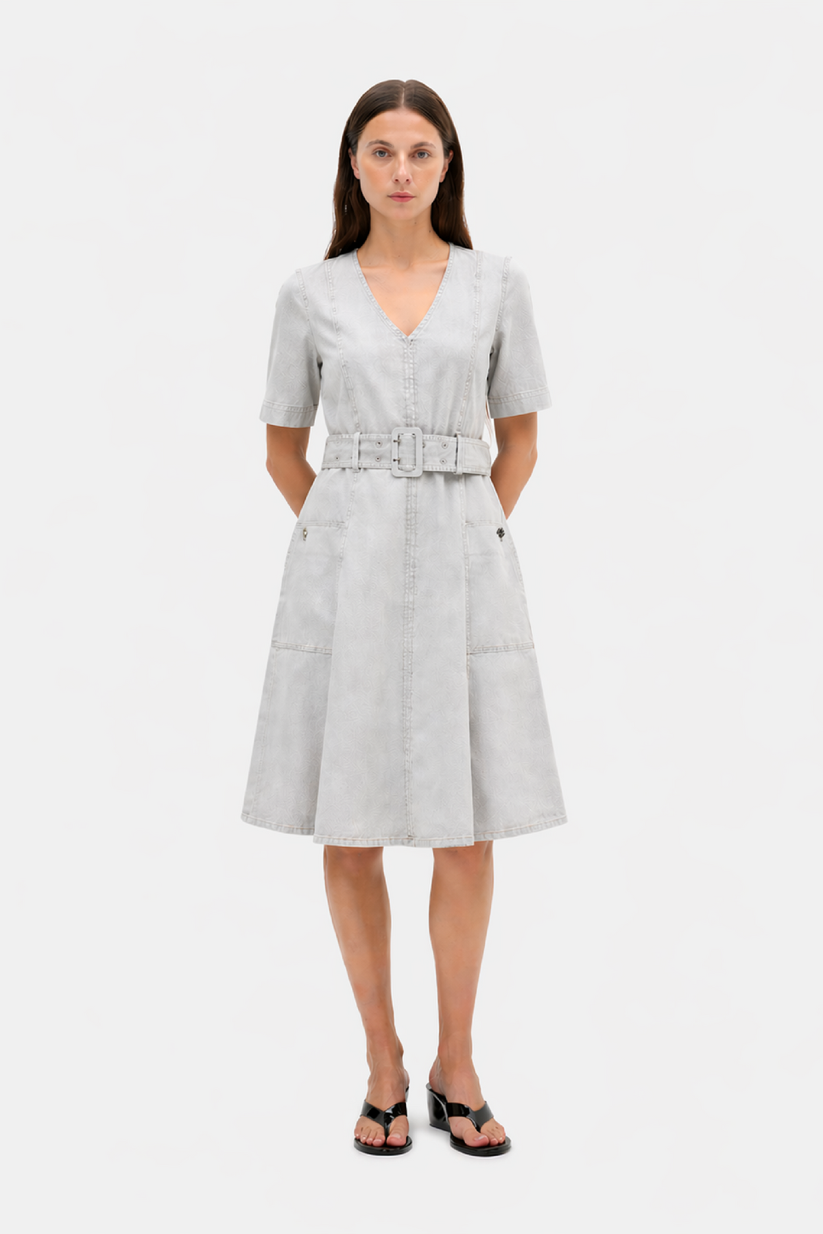 Front view of a light grey short-sleeved V-neck midi dress with panel stitching, a matching wide belt and flared skirt.