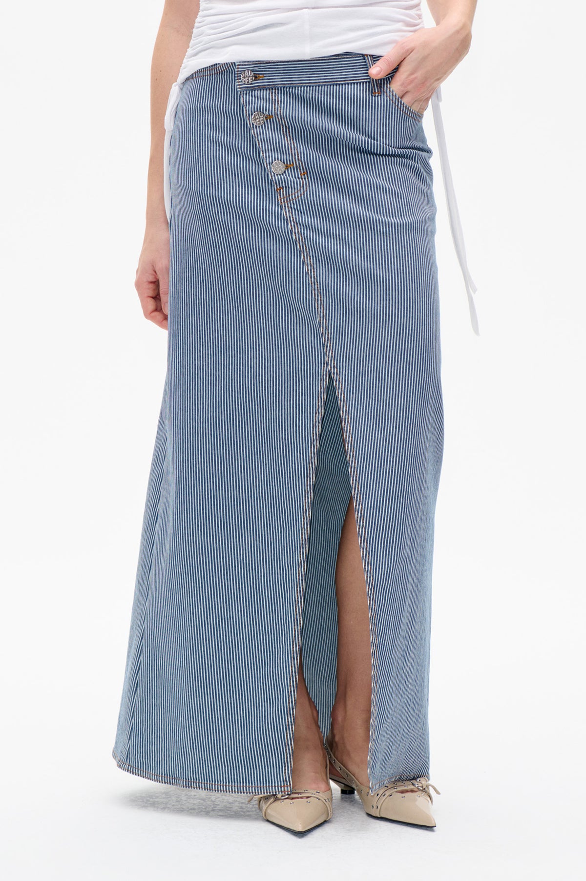 Close-up of a blue-and-white pinstriped long skirt with a buttoned front and high slit
