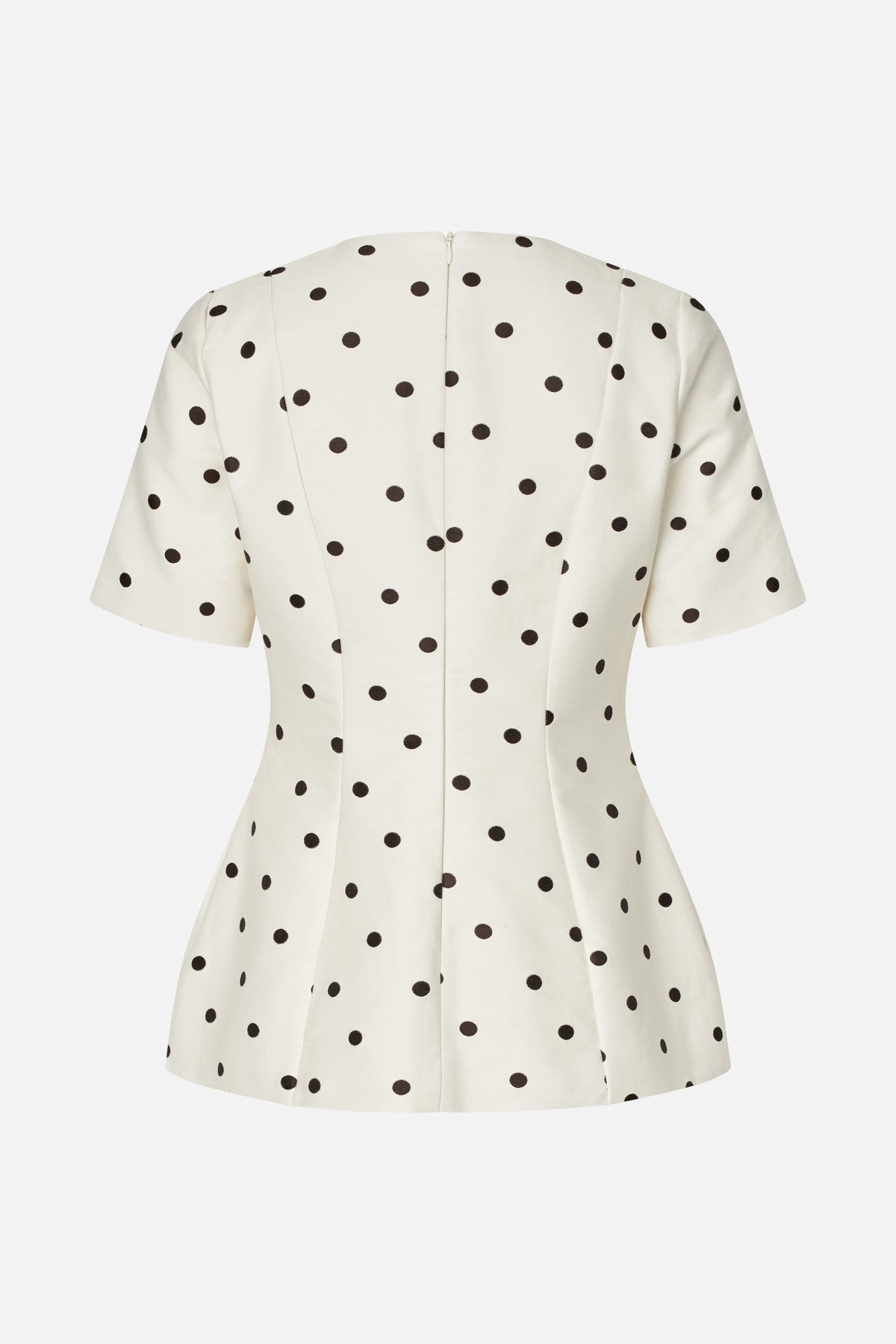 Back view of a cream short-sleeved dress with black polka dots, a fitted waist, flared skirt and center-back zipper.