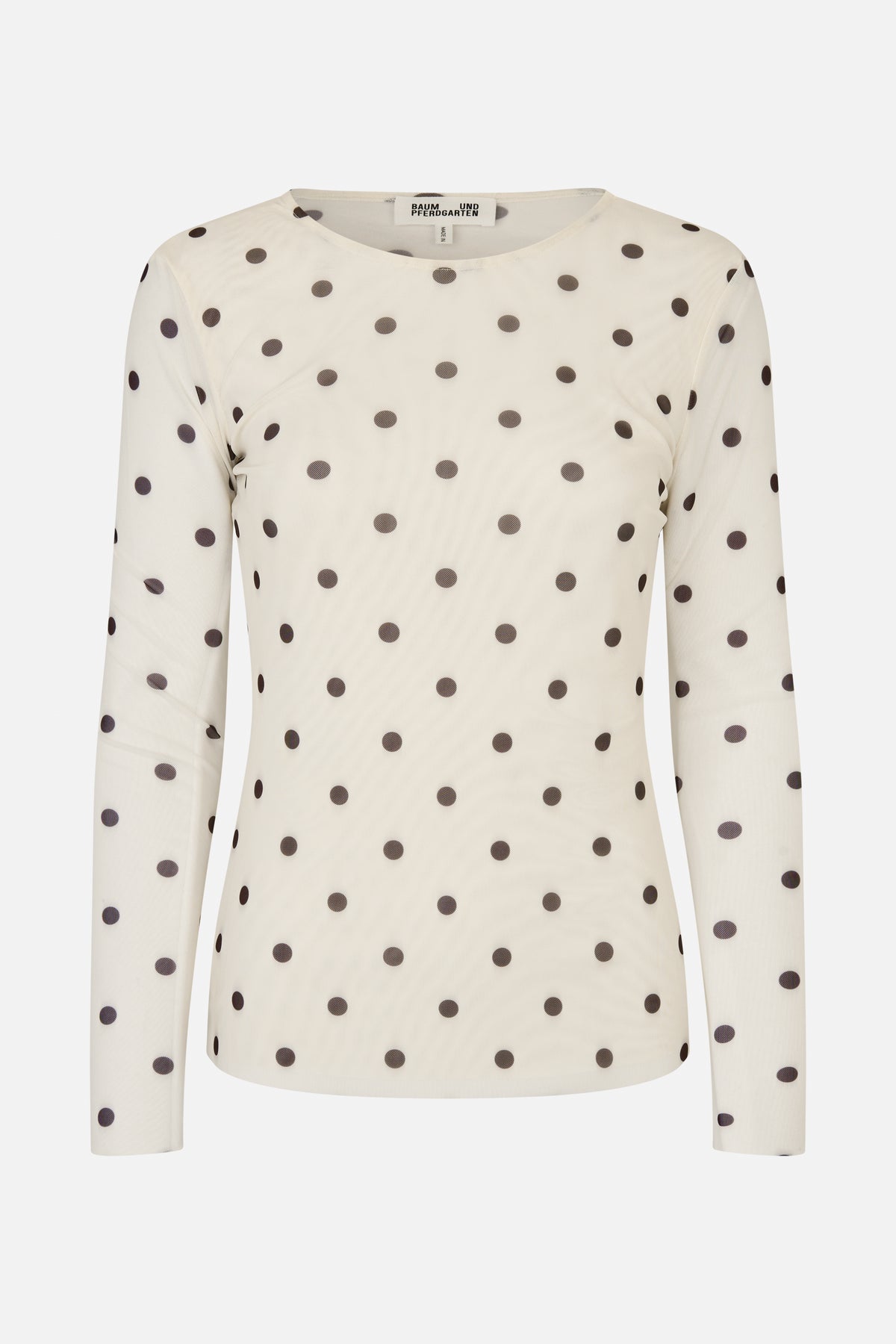 Front view of a cream long-sleeved top with a round neckline and evenly spaced dark polka dots.