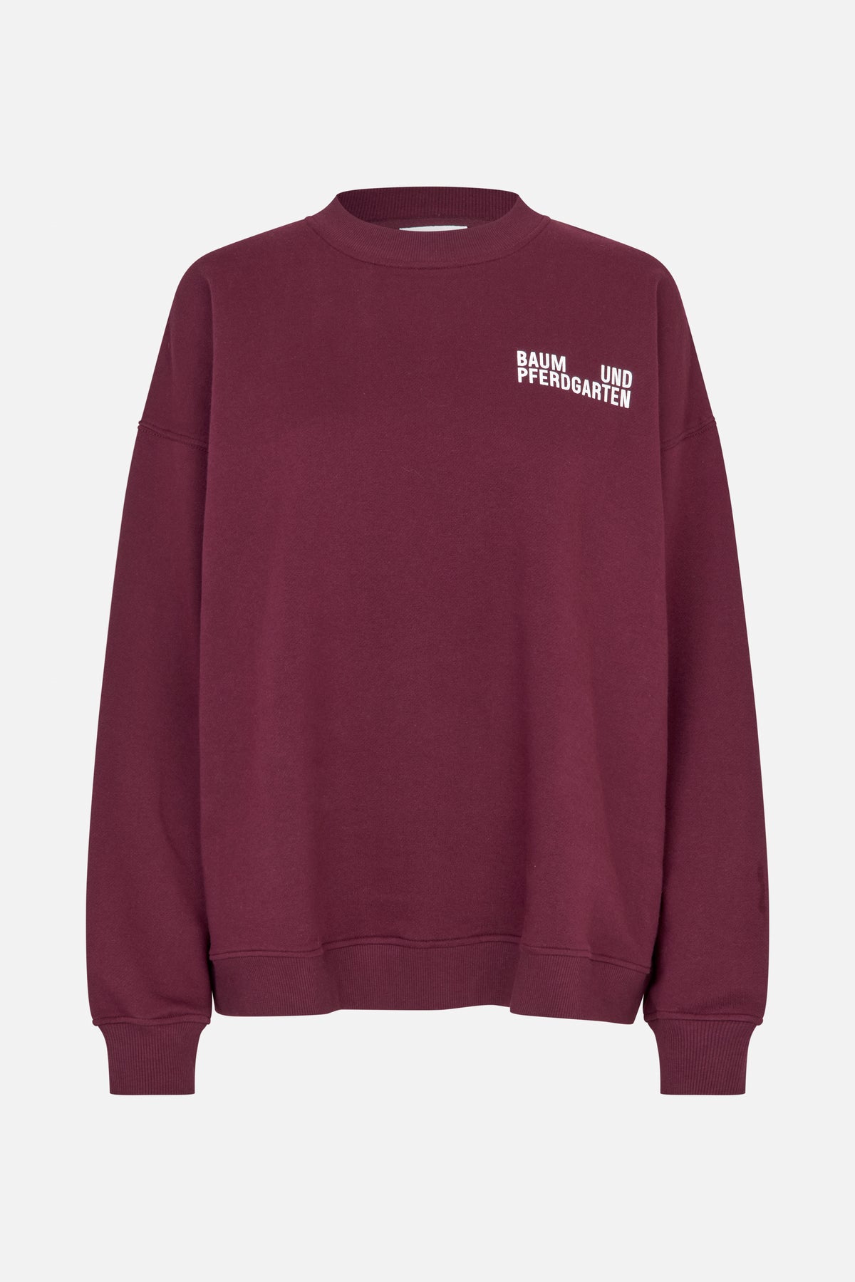 Front view of a burgundy crewneck sweatshirt with ribbed cuffs and hem and white Baum und Pferdgarten lettering on the chest.