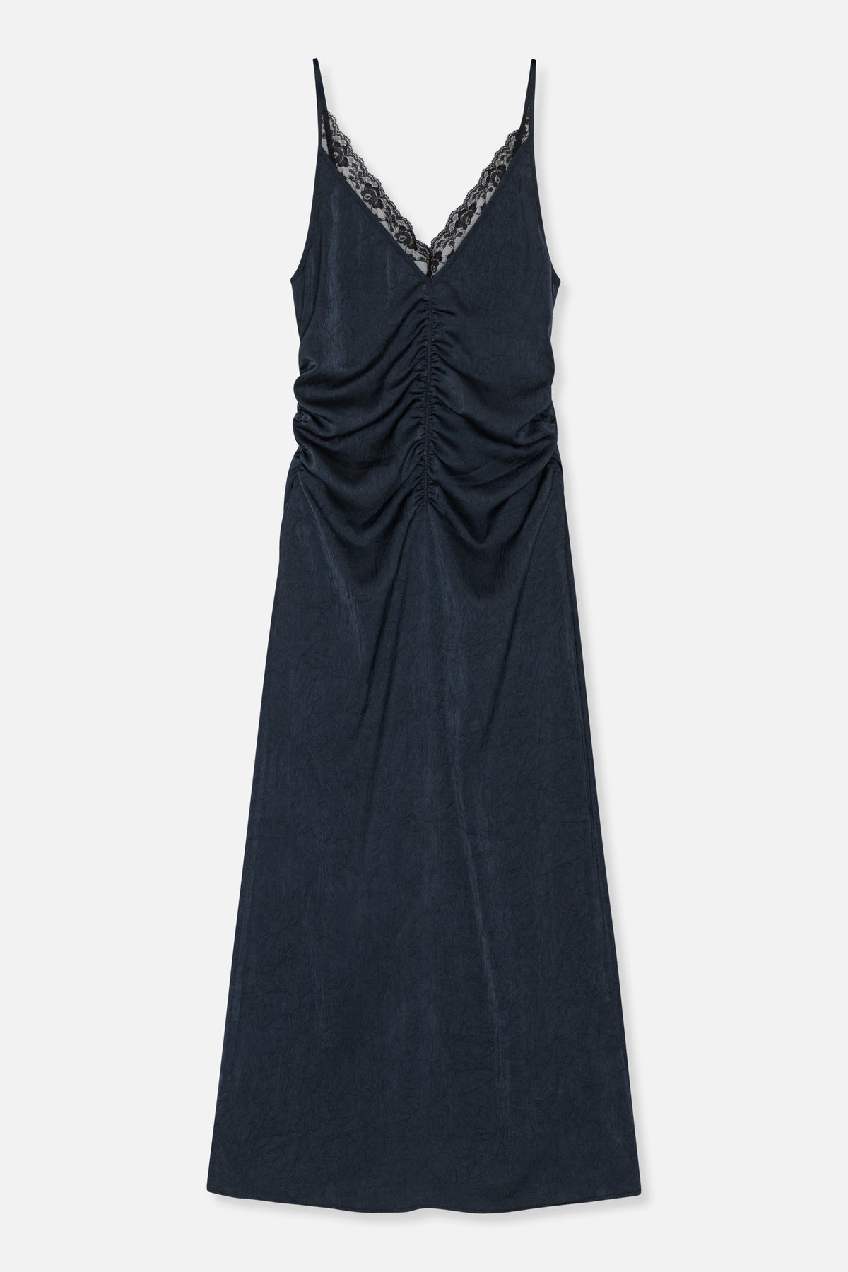 Front view of a long dark navy slip dress with thin straps, a lace-trimmed V-neck and ruching down the centre front.