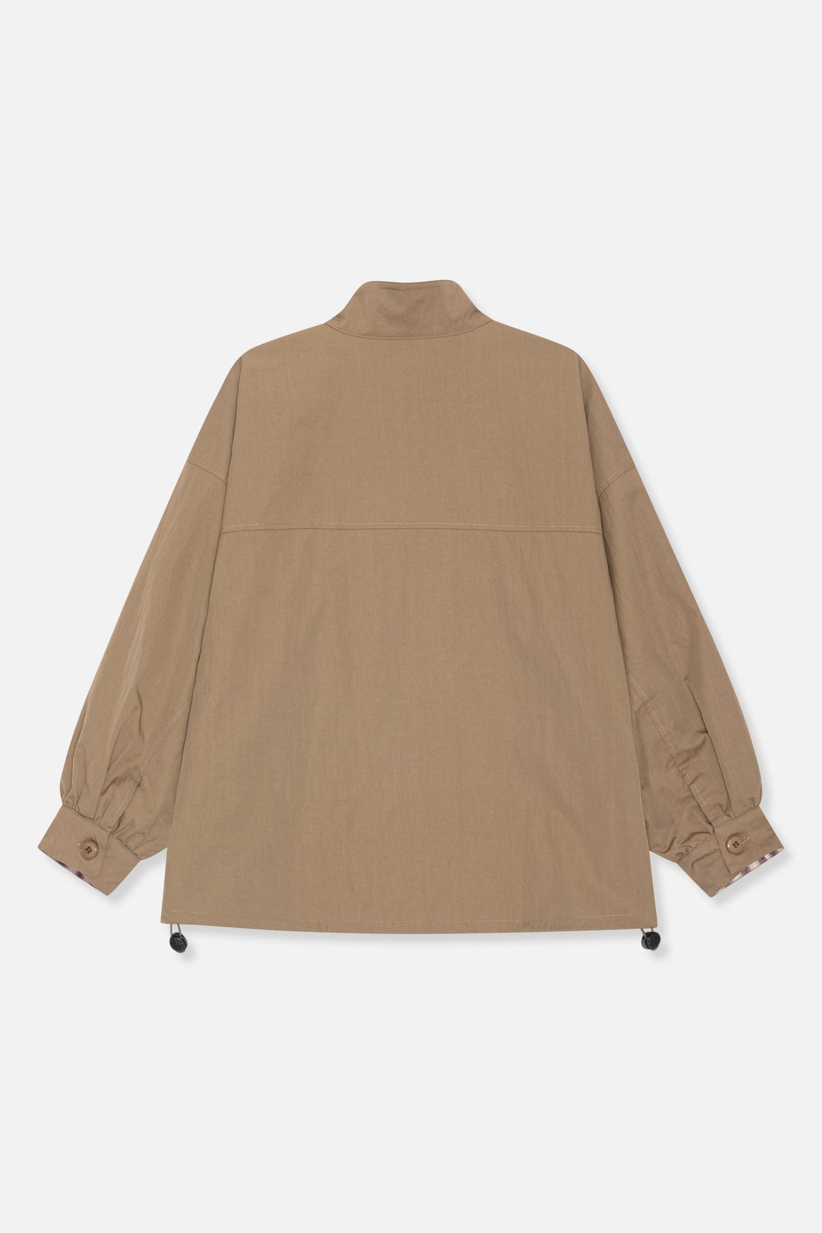 Back view of a tan jacket with a stand collar, stitched panel seams, gathered button cuffs and adjustable hem toggles.