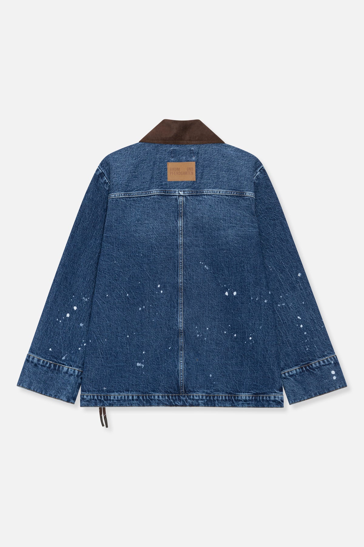 Back view of a blue denim jacket with white paint-like splatters, a brown contrast collar and a tan logo patch.