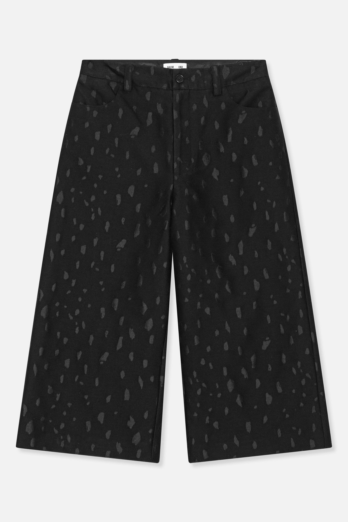 Front view of black wide-leg trousers with an irregular charcoal pattern, button fastening, belt loops and slanted pockets.