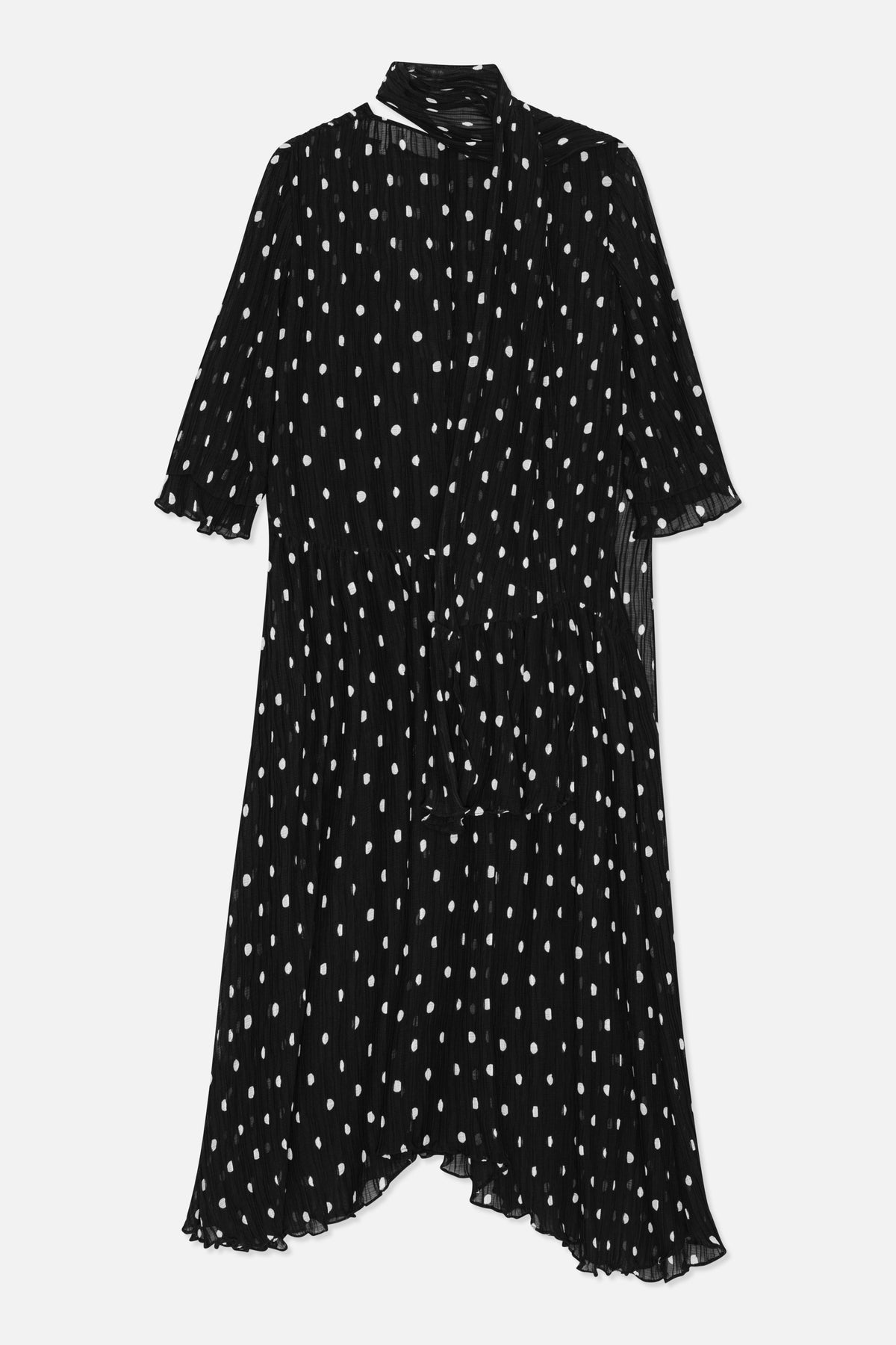 Front view of a black long-sleeved midi dress with irregular white dots, a draped high neck, and a ruffled hem.