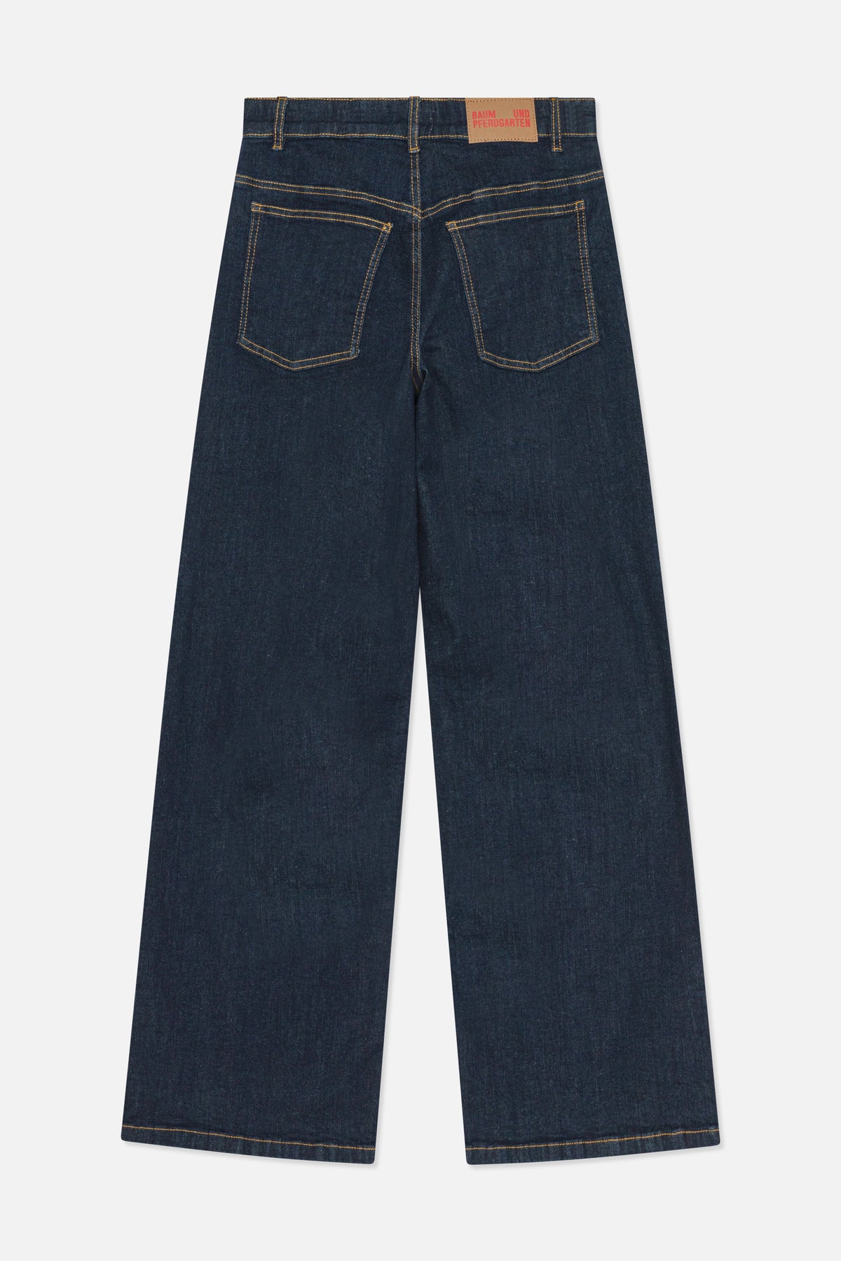 Back view of dark indigo wide-leg jeans with two patch pockets, golden contrast stitching and a Baum und Pferdgarten waistband patch.