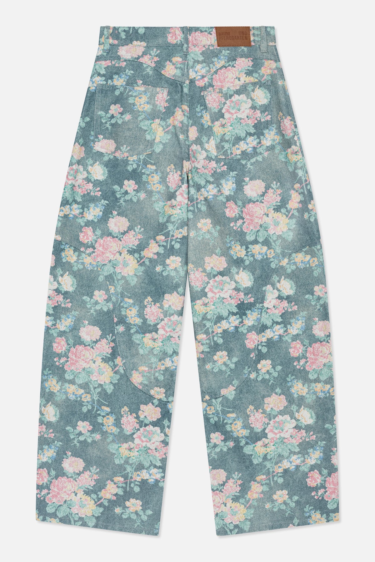 Back view of wide-leg blue denim jeans with an all-over pastel floral print, two patch pockets and a brown waistband label.