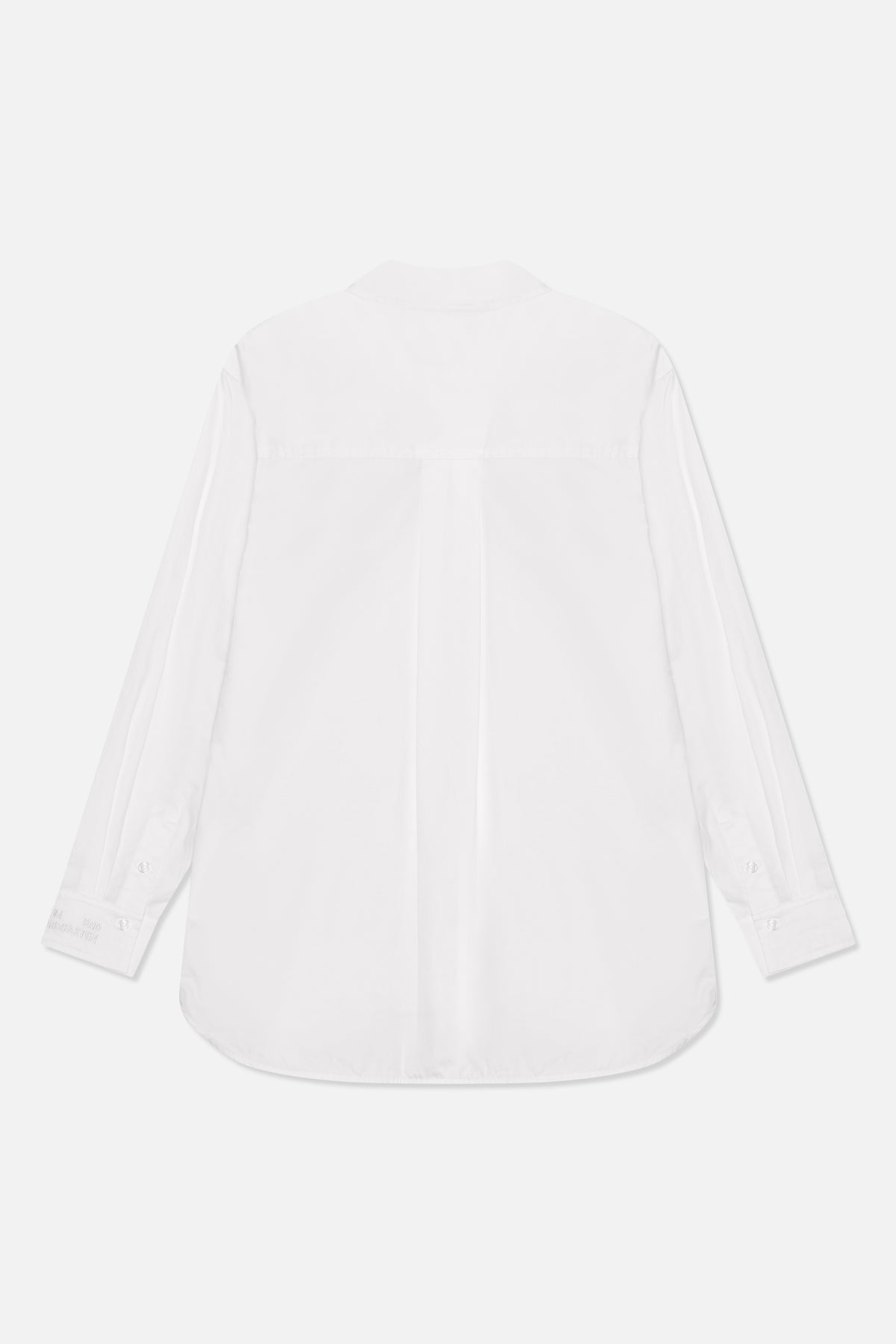Back view of a white long-sleeve button-up shirt with a back yoke, centre pleat, button cuffs and curved hem
