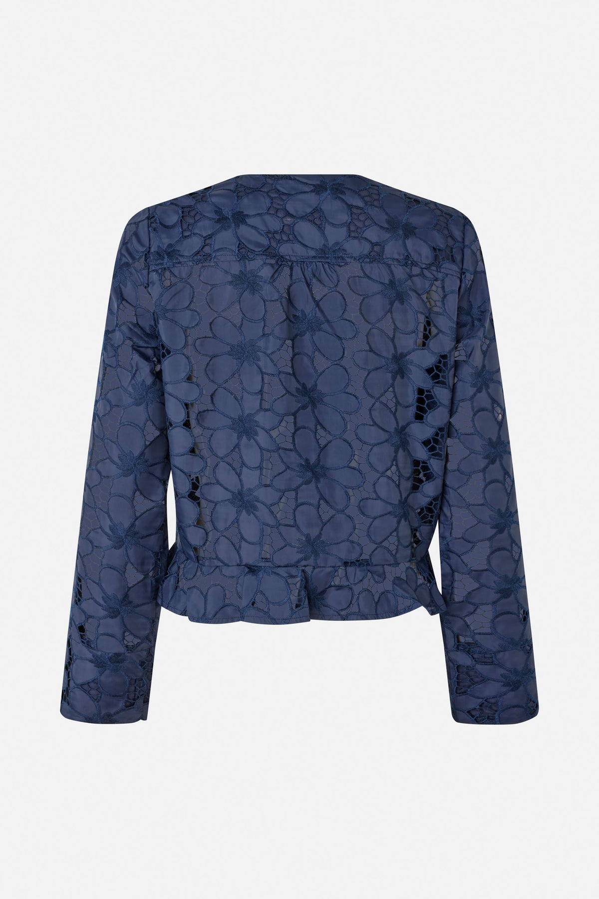 Back view of a navy long-sleeved blouse with floral cutwork and a gathered peplum hem.