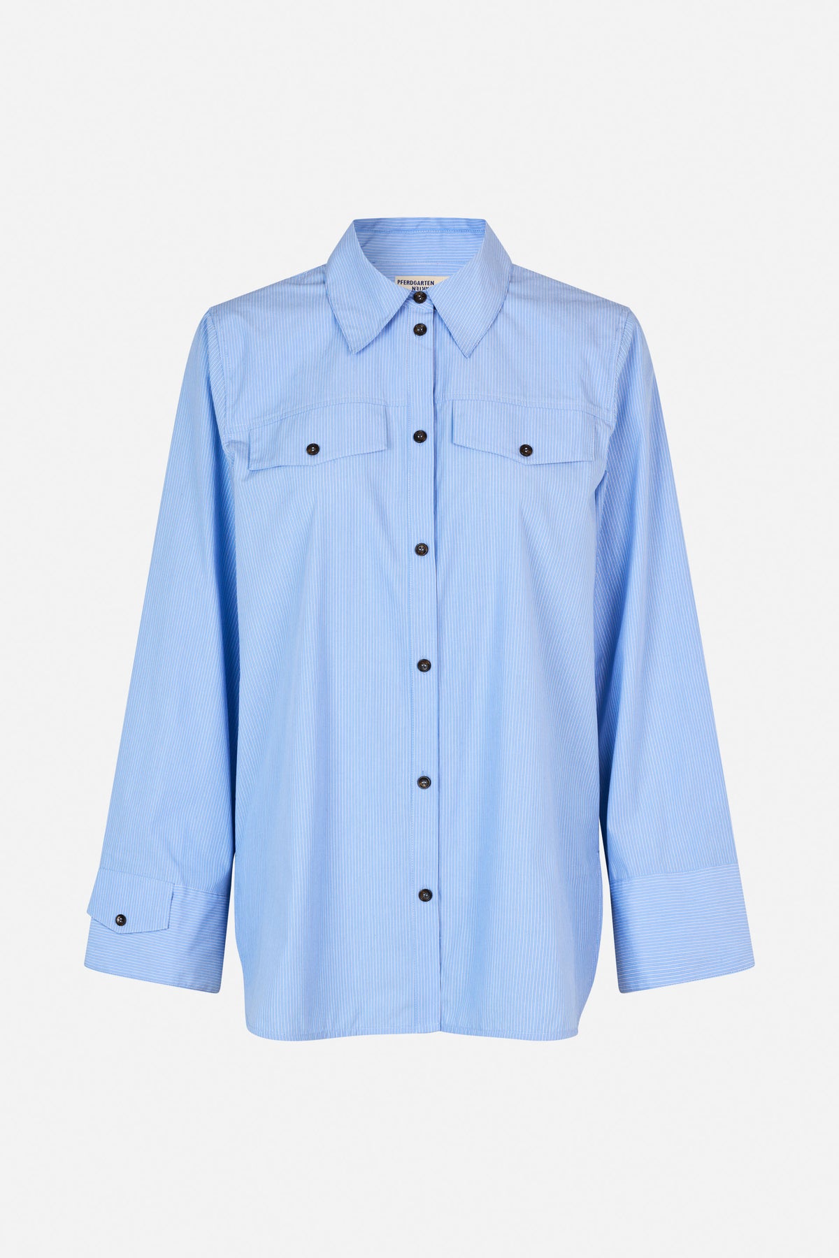 Front view of a light blue shirt with fine white stripes, pointed collar, button front, chest pockets and wide cuffs.