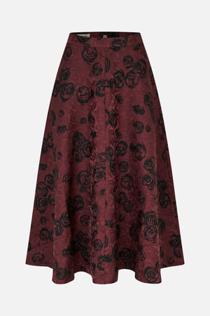 Front view of a flared burgundy skirt with an all-over black rose print and a wide waistband.