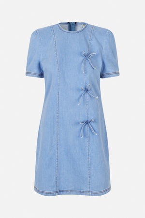 Front view of a light blue denim dress with short puff sleeves, contrast stitching and bow-tie closures along the side.