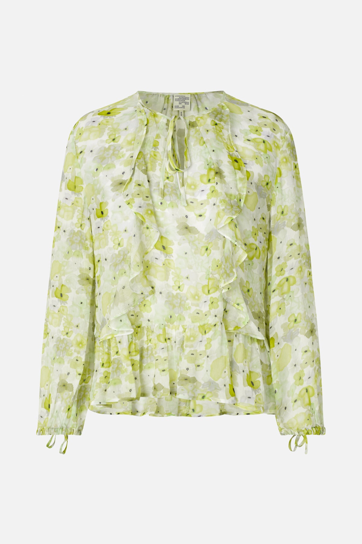 Vue de face d'une blouse à manches longues au motif floral vert pâle et blanc, volants superposés sur le devant, encolure à nouer et poignets ornés de rubans.