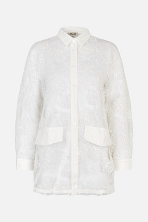 White long-sleeved button-up shirt with a pointed collar, floral lace pattern, chest pockets and wide cuffs, shown from the front