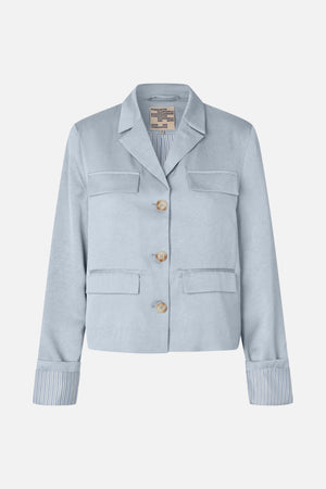 Front view of a pale blue textured blazer with notched lapels, four flap pockets, beige buttons and striped lining at the cuffs.