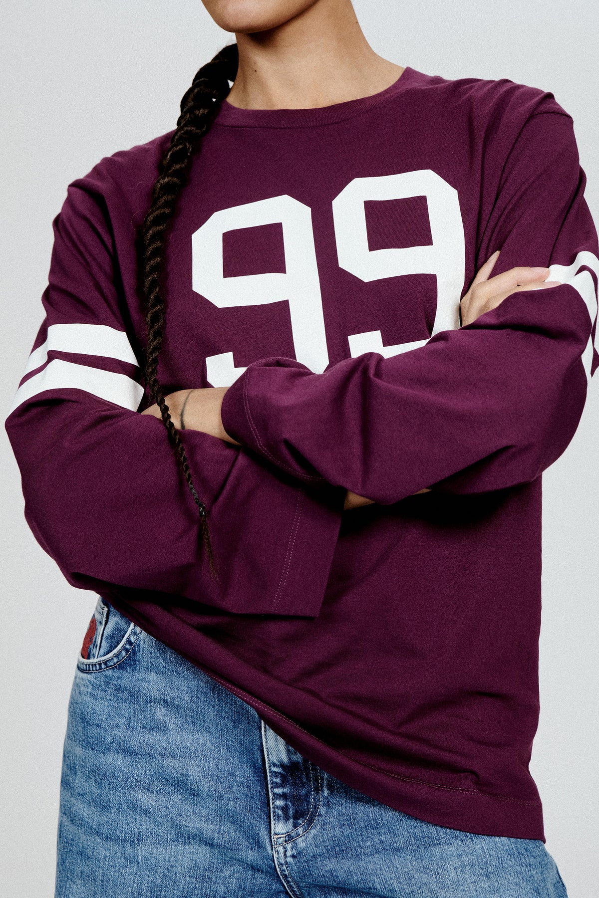 Close-up front view of a plum long-sleeved T-shirt with a large white “95” graphic and white sleeve stripes.