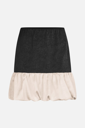 Two-tone skirt with a crinkled black upper panel and a gathered, voluminous ivory hem.