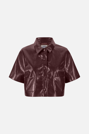 Front view of a glossy burgundy short-sleeved jacket with a pointed collar, covered buttons and two patch pockets.