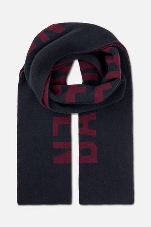 Long dark navy knitted scarf with burgundy geometric lettering, folded and draped to show its pattern.