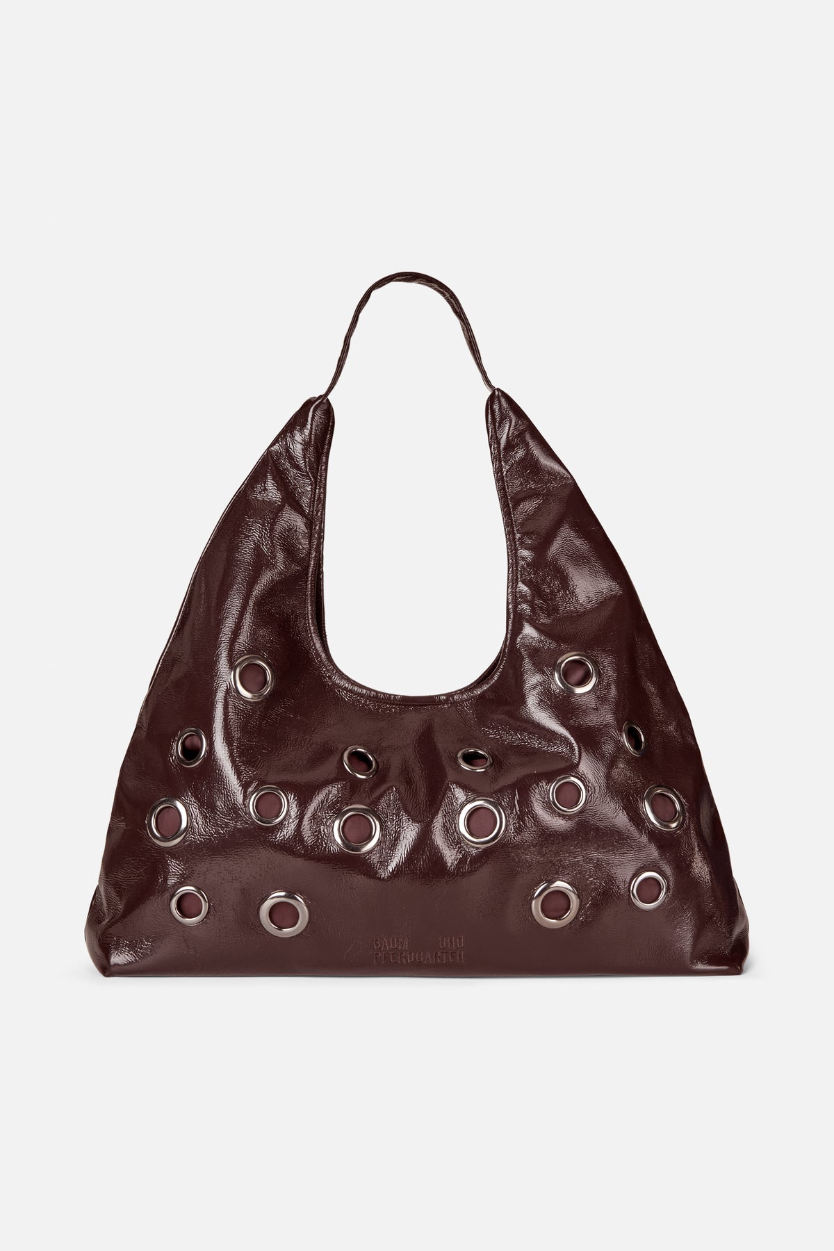 Dark brown glossy slouchy shoulder bag with a single handle and rows of large silver-tone eyelets, shown from the front.
