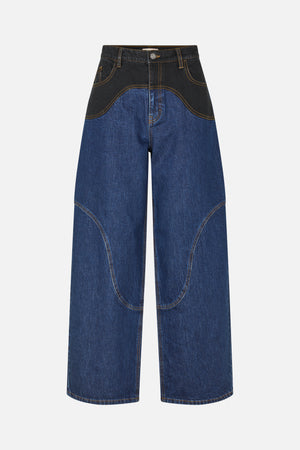 Front view of wide-leg blue jeans with a black upper panel, curved contrast seams and tan stitching.