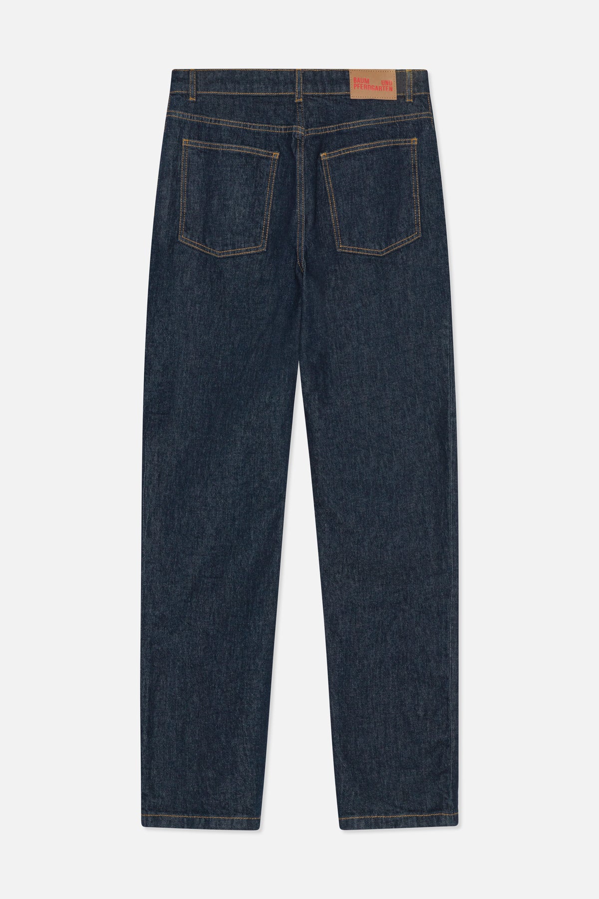 Back view of dark indigo straight-leg jeans with two patch pockets, ochre contrast stitching and a tan waistband label.
