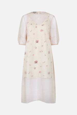 Front view of an ivory sheer dress with scattered pink floral print, a pleated bodice, and three-quarter puff sleeves.