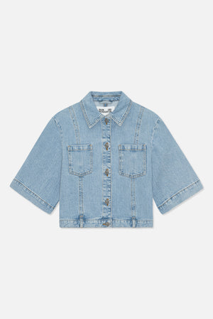 Front view of a light blue denim jacket with a pointed collar, short wide sleeves, two chest pockets and metal buttons.