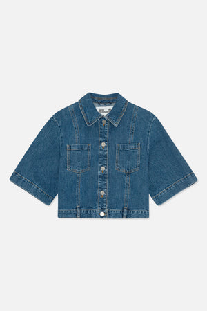 Front view of a blue denim jacket with short wide sleeves, pointed collar, button front, contrast stitching and two chest pockets.