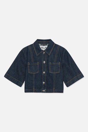 Front view of a dark indigo denim jacket with short wide sleeves, contrast stitching, pointed collar, silver buttons and two patch pockets.