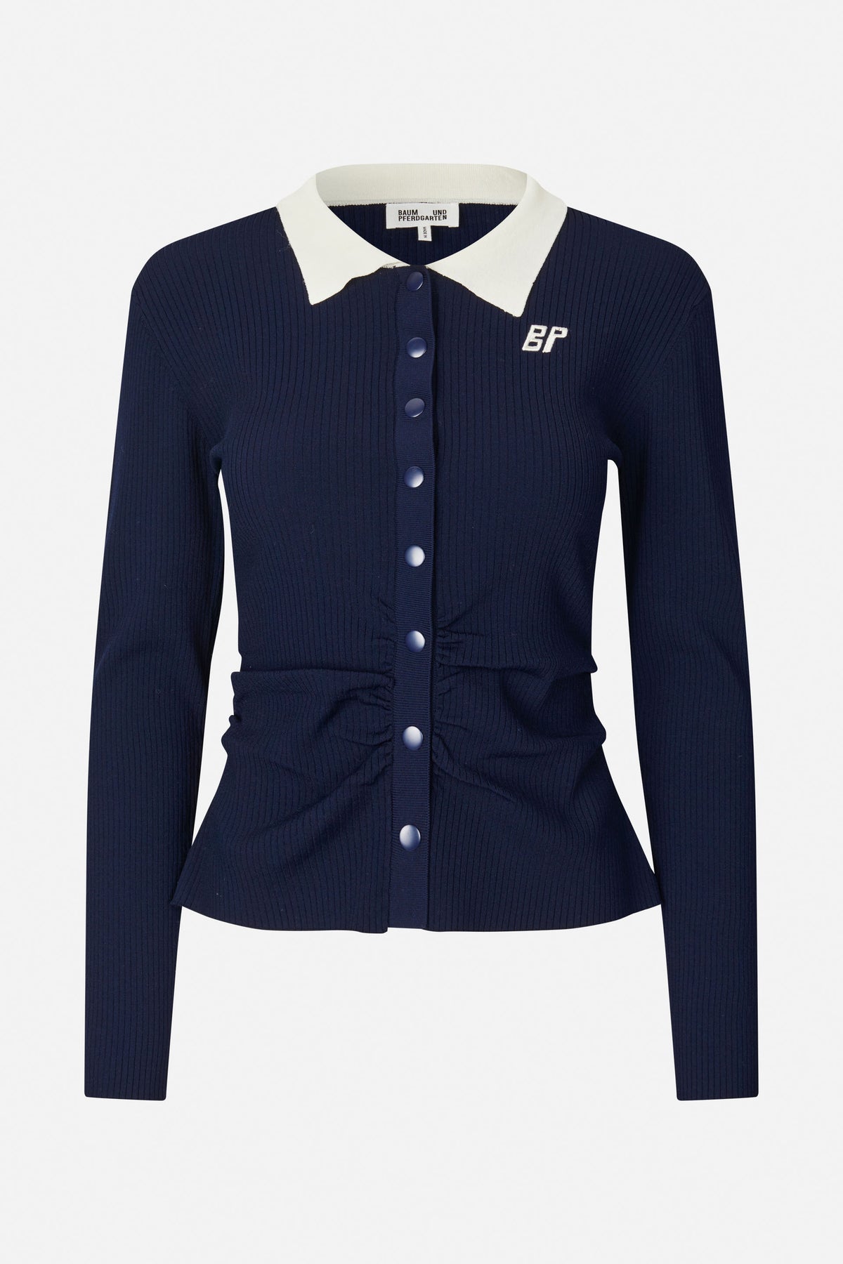 Front view of a navy ribbed cardigan with a white pointed collar, matching buttons and a small embroidered monogram.