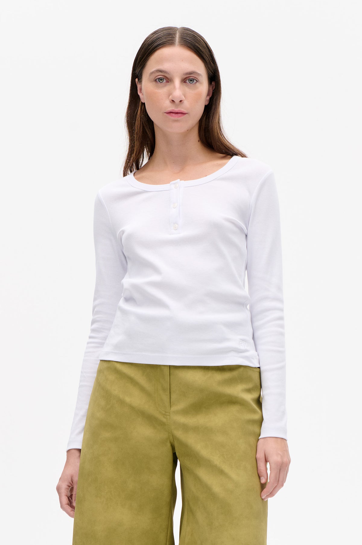 Front view of a white long-sleeved top with a round neckline and short button placket, paired with olive-green trousers.