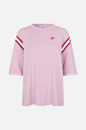 Front view of a light pink short-sleeved T-shirt with red and white sleeve stripes and a small red BP chest emblem.