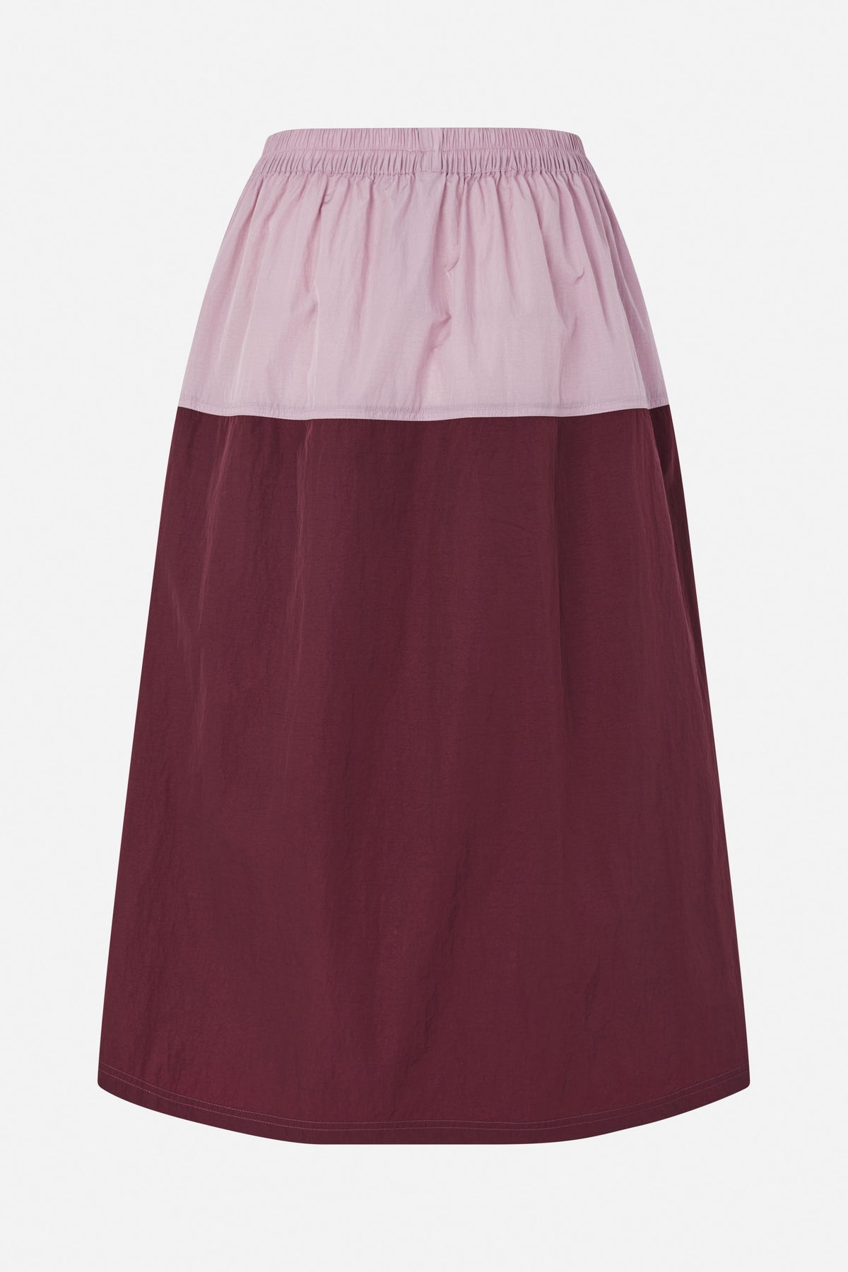 Front view of a two-tone skirt with a gathered pale pink elastic waistband and upper panel, and a deep burgundy body.